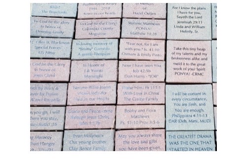 Engraved bricks with various personalized messages.