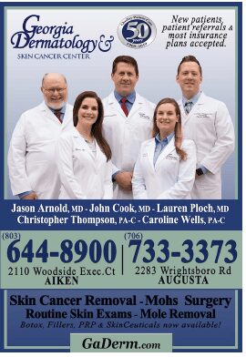 Five dermatologists smiling in white coats