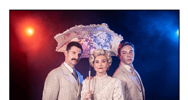 Three people in vintage attire with parasol.