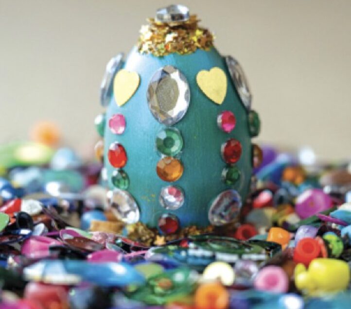Decorated egg with colorful gems and sequins.