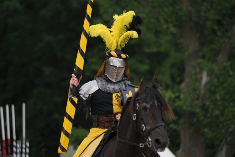 A medieval knight in armor with lance on horseback during a jousting event in Germany.
